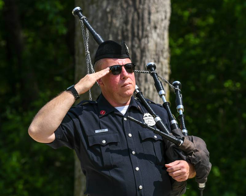 Tom Conley of DeKalb salutes the flag as the colors are dismissed during the Memorial Day ceremony held at the Ellwood lawn in DeKalb on Monday May 30th.