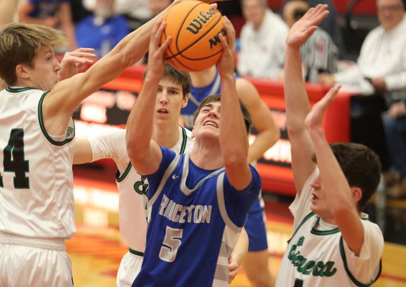 Princeton's Jack Oester eyes the hoop against Eureka defenders during the Colmone Classic on Thursday, Dec. 11, 2025 at Hall High School.