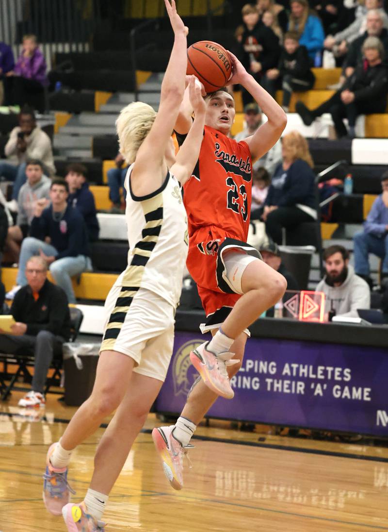 Sandwich's Chance Lange gets a shot off over Sycamore's Aidan Wyzard at the first half buzzer during their game Friday, Nov. 24, 2023, in the Leland G. Strombom Holiday Tournament at Sycamore High School.