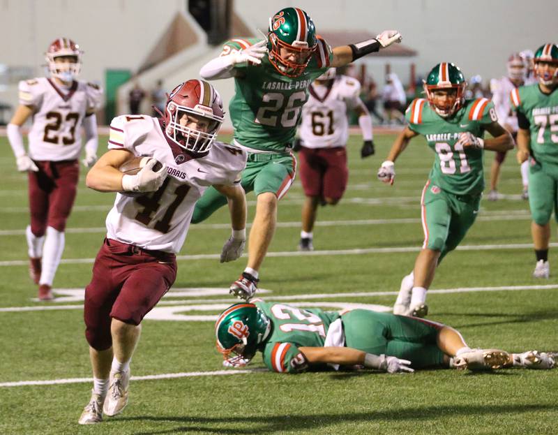 Morris's Keegan Kjellesvik sprints down the field as L-P's Griffin May hurdles over teammate Rylynd Rynkewicz to chase him down on Friday, Sept. 20, 2024 at Howard Fellows Stadium.