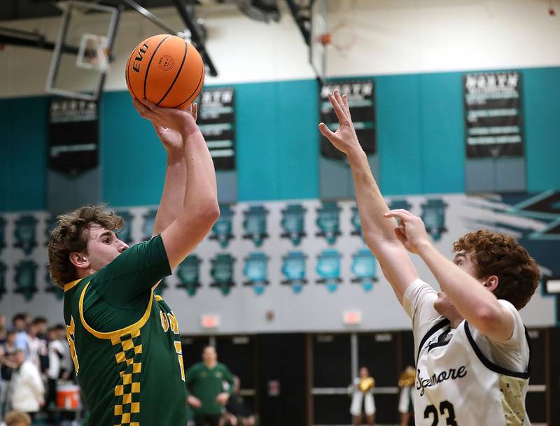 Crystal Lake South's Ryan Morgan sjhoots the ball Sycamore's Aidan Mesenbrink during an IHSA Class 3A Woodstock North Sectional semifinal.basketball game on Wednesday, March 4, 2025, at Woodstock North High School.