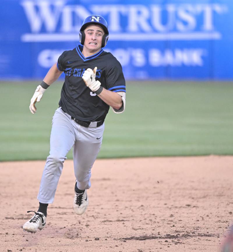 St. Charles North’s Jaden Harmon rounds the bases with an RBI triple against St. Charles East in the third game of their inter-city series at Northwestern Medicine Field in Geneva on Tuesday, April 20, 2024.