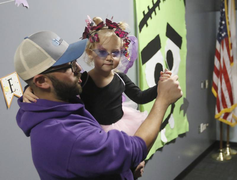 Shawn Polinovski, of Lake in the Hills, dances with his daughter, Milana, 2, during a Halloween dance party Wednesday, Oct. 19, 2022, at the Algonquin Area Public Library, 2600 Harnish Drive in Algonquin.