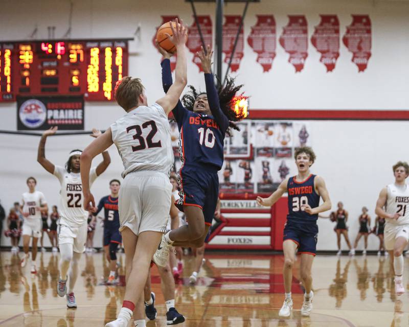 Oswego's MJ Johnson (10) puts up a shot after a steal during their basketball game between Oswego at Yorkville Friday, Dec 12, 2025 in Yorkville.