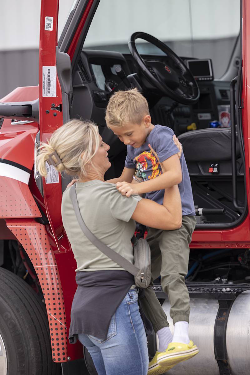 Michelle Fassler helps son Everett, 6, down from exploring a big truck Tuesday, Aug. 6, 2024 during National Night Out in Dixon.