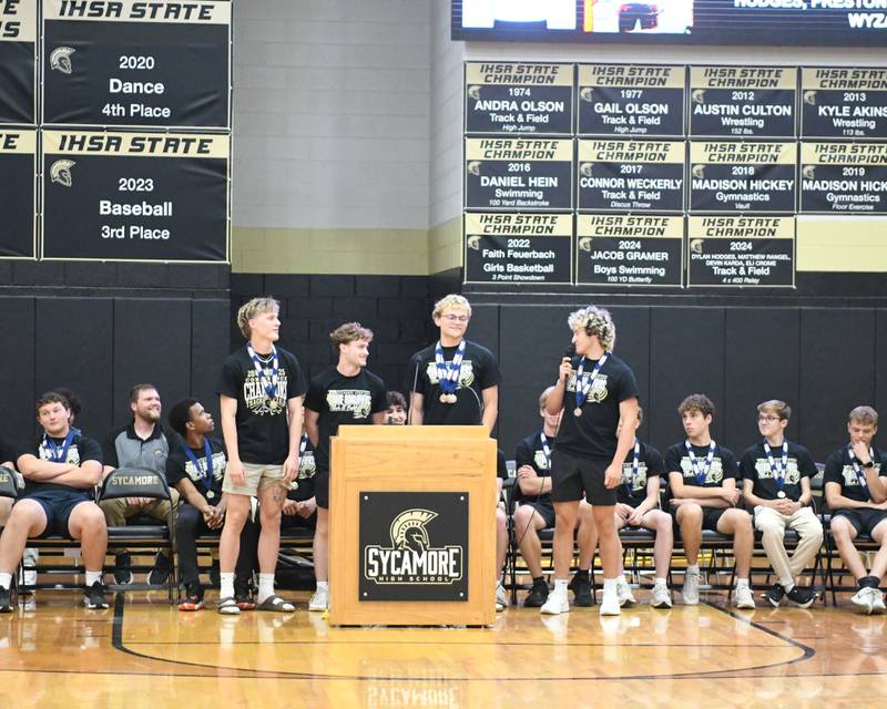 Sycamore’s 4x100 relay Vasilios Arhos, Dylan Hodges, Preston Picolotti, and Aidan Wyzard talks during the pep rally on Tuesday June 4, 2025, at Sycamore High School after the team brought back the championship trophy.