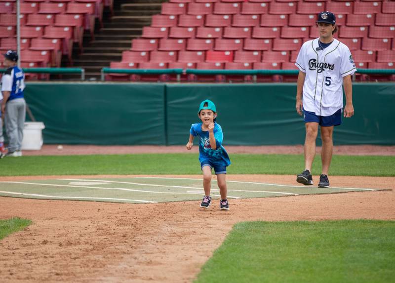 Violet Belmonte (6) of Carpentersville runs to first base at the base running station of the Kane County Cougar's Youth Clinic at Northwestern Medicine Field on Saturday, July 16, 2022.