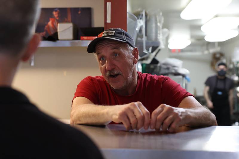 Mike Hufendick talks with Paul Lichamer while his order is put together at Hufendick Farm Market in Downtown Plainfield on Tuesday, February 21st, 2023.