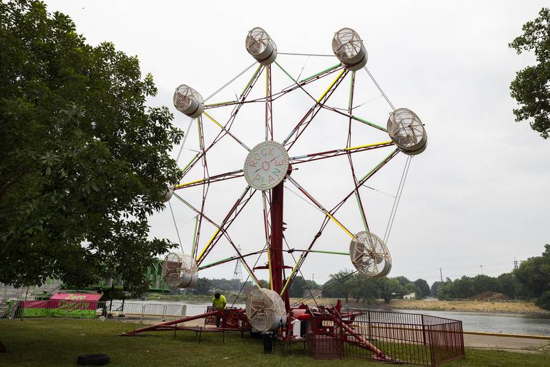 A worker puts the final touches on a ride Monday, June 26, 2023 while preparing for the Dixon Petunia Fest carnival. The carnival will kick off Friday from 3 to 5 pm with a quiet period for special needs families.