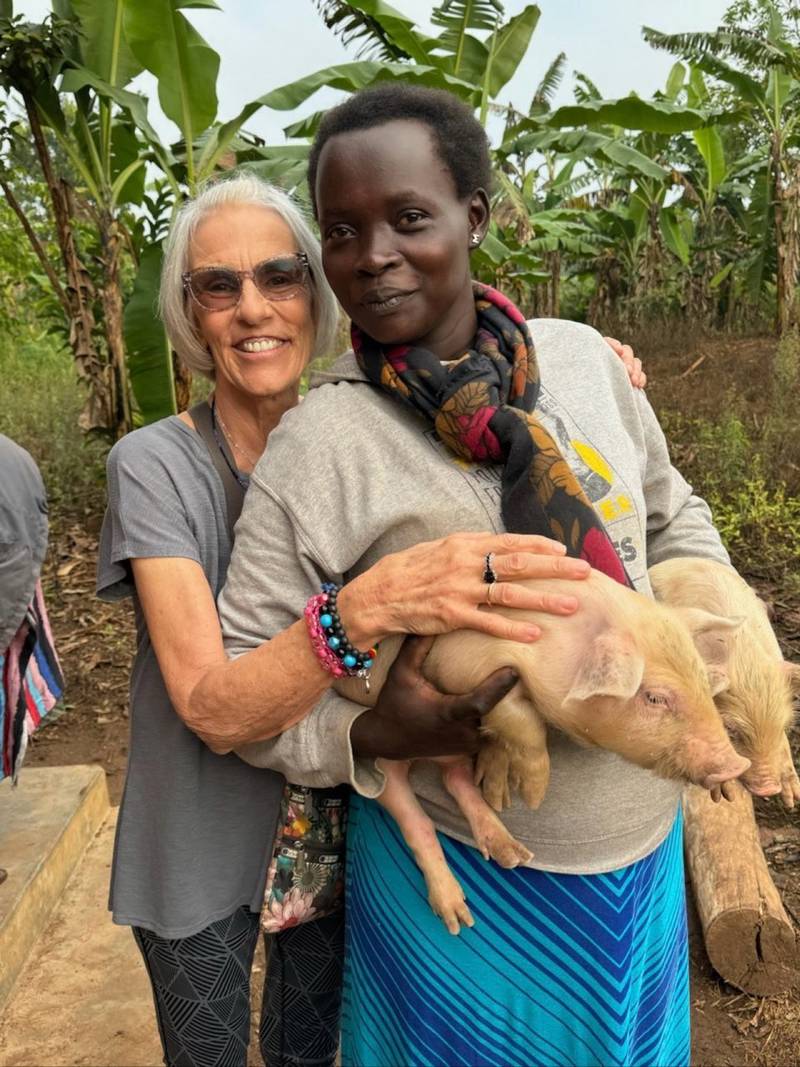 Debbie Damron, left, of Ottawa with Mercy Anna – a member of the first family Damron sponsored in 2008 – on pig distribution day.