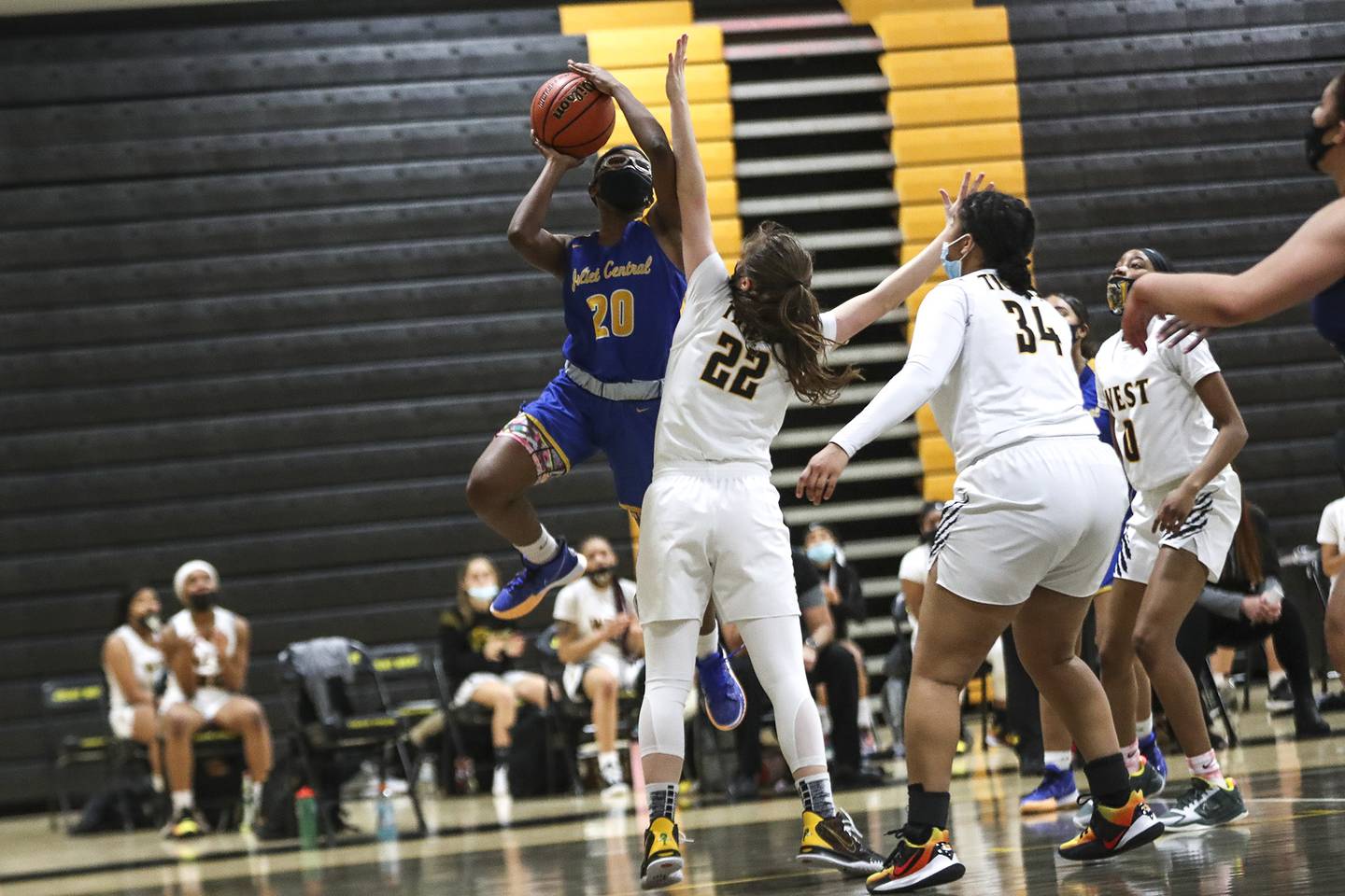 Joliet Central's Ashanti Brown makes a contested layup on Tuesday, Feb. 16, 2021, at Joliet West High School in Joliet, Ill.