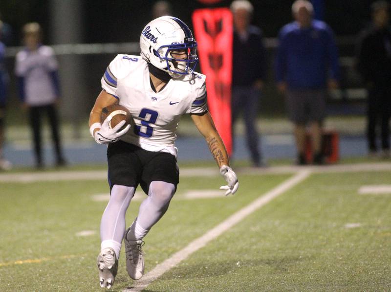 St. Charles North’s Jake Mettetal runs the ball during a game at Wheaton North on Friday, Sept. 8, 2023.