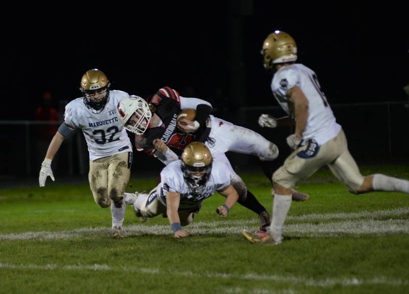 Forreston's Dane Stetterstrom hangs on to the ball at the end of a run during 1A football playoff action against Ottawa Marquette on Friday, Oct.27, 2023 at Forreston High School.