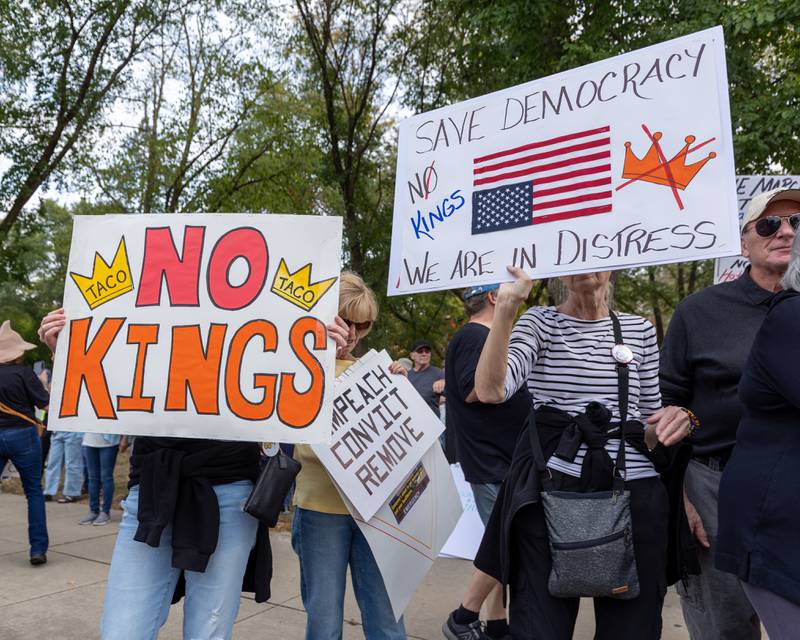 Protesters hold signs in spirit of the ‘No Kings 2.0’ Protest on Saturday, October 18, 2025 at Washington Square Park in Ottawa.