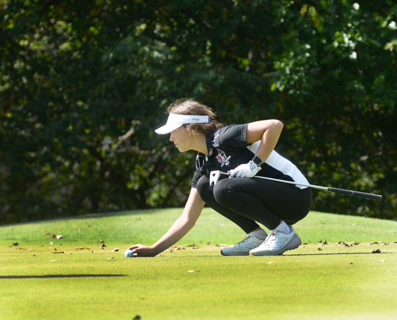 Erie-Prophetstown's Michelle Naftzger lines her ball up for a putt  at the 1A regional at Wolf Hollow Golf Course in Lena on Tuesday, Oct. 1, 2024.