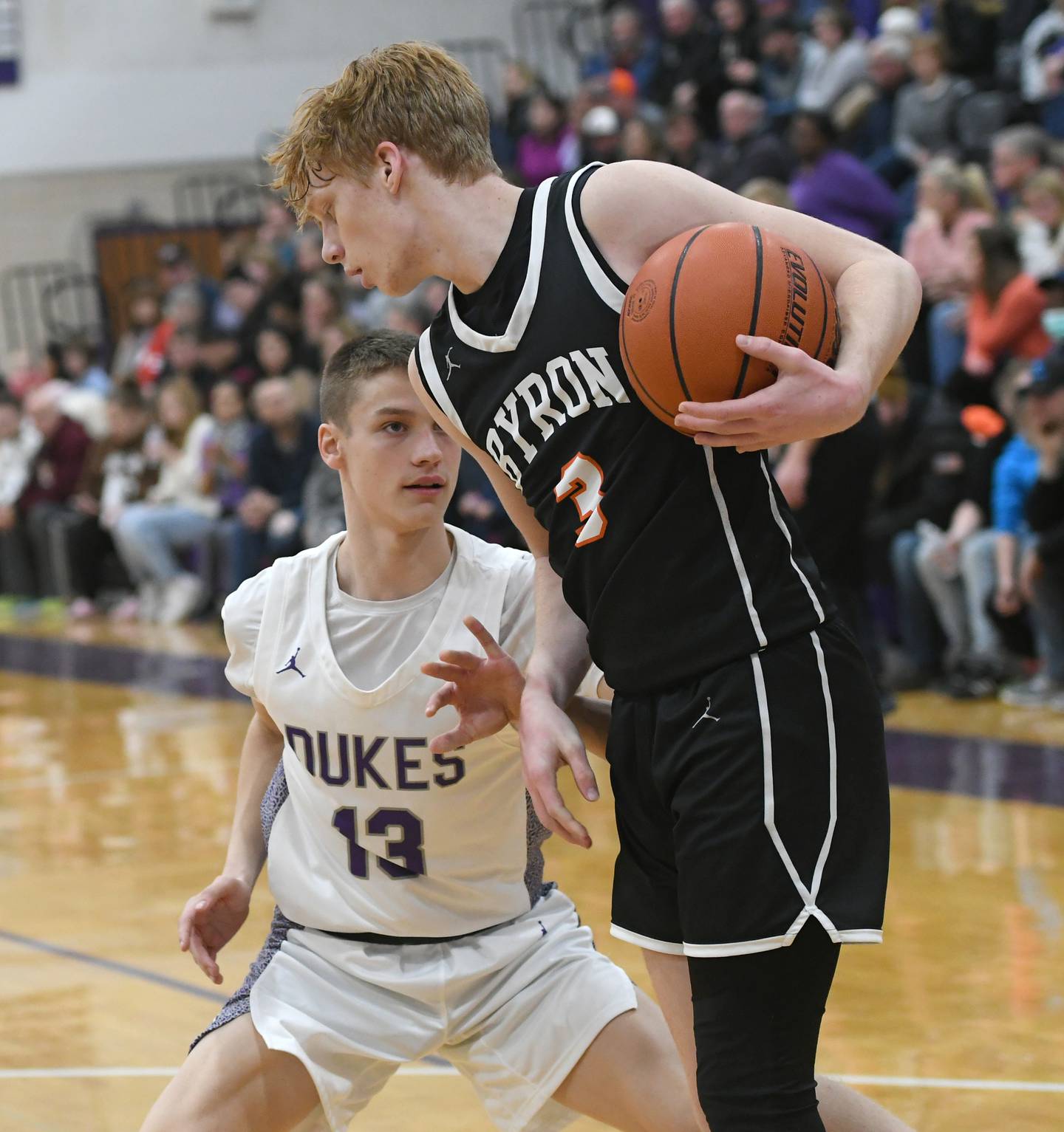 Dixon's Cullen Shaner (13) looks to steal the ball from Byron's Carson Buser (3) during Big Northern Conference action on Tuesday, Jan. 31 at Lancaster Gym.