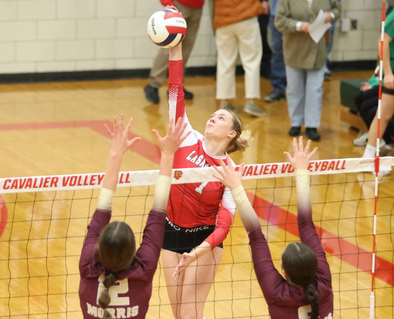 L-P's Aubrey Duttlinger sends a spike past Morris's Lily Hansen and teammtate Alexis Wiliams during the Class 3A Sectional semifinal game on Tuesday, Nov. 4, 2025 in Sellett Gymnasium at L-P High School.