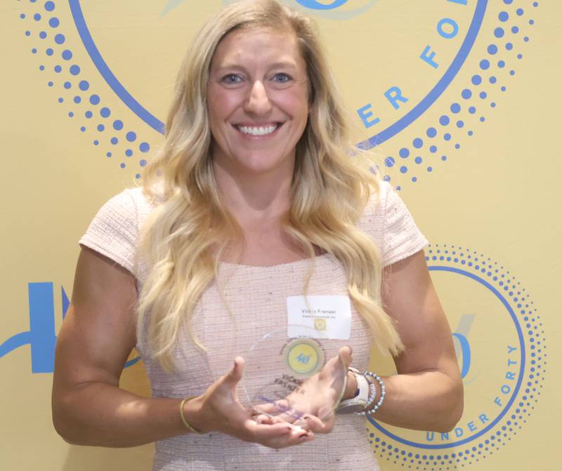 Vickie Frenzer poses with her 40 Under Forty award during the Illinois Valley Chamber of Commerce Champions of Change Awards Night on Wednesday, May 6, 2026 at the Westclox Event Center in Peru.