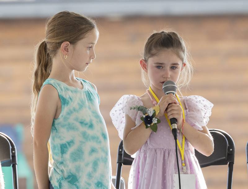 Charlotte Bartlett (right), 5, gets support from her sister while singing “Twinkle, Twinkle, Little Star,” Thursday, June 26, 2025, during Polo’s Little Miss and Mister pageant.