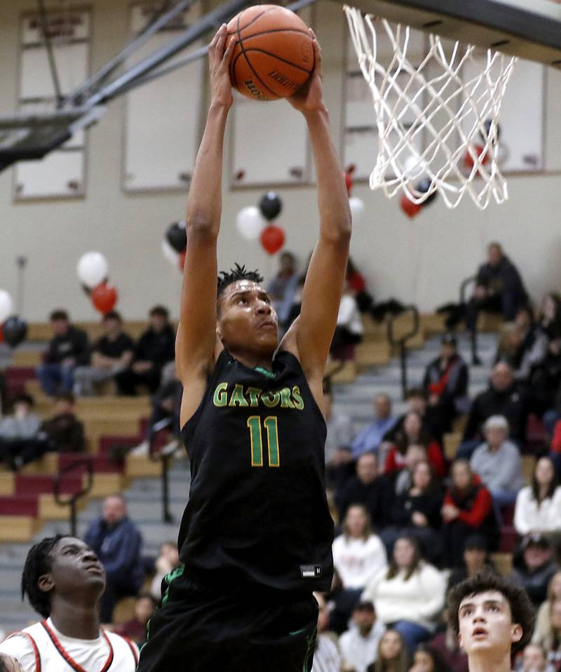 Crystal Lake South's Christian Rohde ducks the ball during a Fox Valley Conference boys basketball game against Huntley on Tuesday, Feb.6, 2024, at Huntley High School.