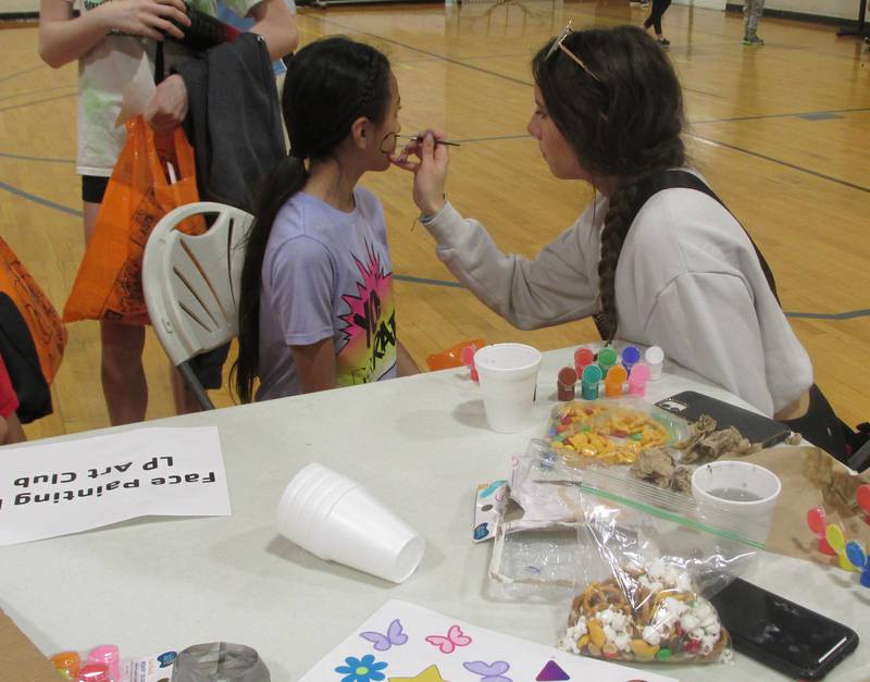 Yazlin Mandujano gets her face painted Saturday, April 29, 2023, during the Illinois Valley YMCA's Healthy Kids day.