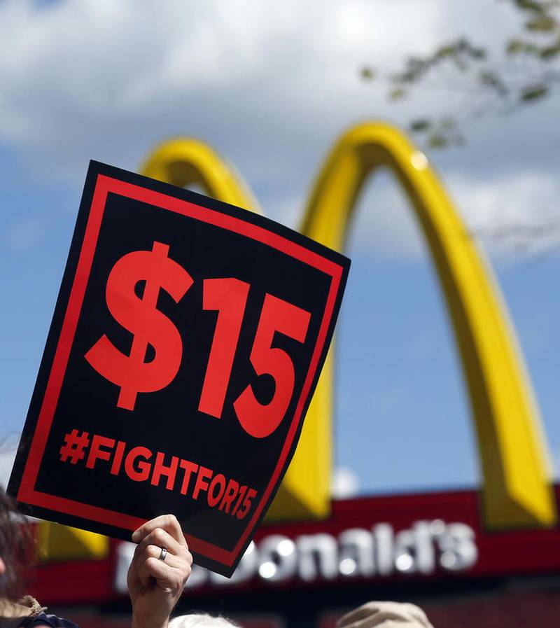 FILE - In this July 22, 2015 file photo, supporters of a $15 minimum wage for fast food workers rally in front of a McDonald's in Albany, N.Y. Millions of workers across the U.S. will see their pay increase as 19 states bump up their minimum wages as the new year begins. California, New York and Arizona are among the states with increases taking effect Saturday, Dec. 31, 2016 or Sunday, Jan. 1, 2017. New York state is taking a regional approach, with the wage rising to $11 in New York City, $10 in its suburbs and $9.70 upstate. (AP Photo/Mike Groll, File)