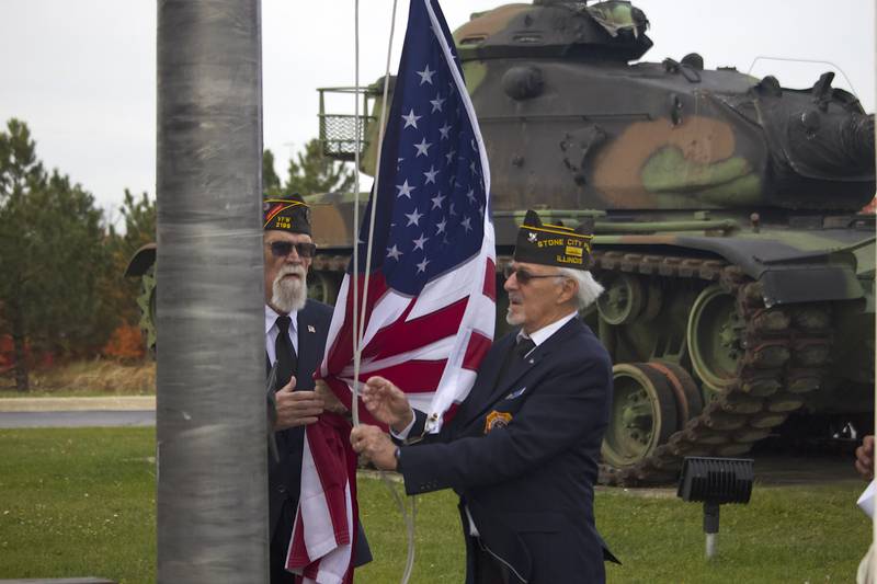 Stone City VFW Post 2199 members Mike Scovel (left) and Edward Chartrand, the latter of whom is a chaplain, work to raise the U.S. flag for Veterans Day at the VFW Post at 124 Stone City Drive, Joliet, on Tuesday, Nov. 11, 2025.