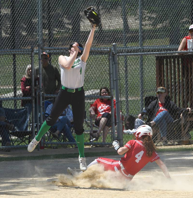 Rock Falls third baseman Rylee McFadden jumps to catch a throw as Oregon's Ashlee Mundell slides safely to the bag during the championship game of the 2A Oregon Regional on Saturday, May 23, 2026 at Oregon Park West.