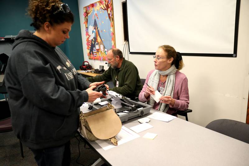 Election Judges Jim Locke (center) and Karen Brooker help voter Nicole Cantafio of Elburn at the Town and Country Library in Elburn for the General Election on Tuesday, Nov. 8, 2022.