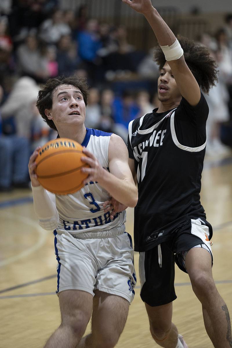 Newman’s Garret Matznick puts up a shot against Kewanee’s Catrelle Reed Friday, Jan. 10, 2025.