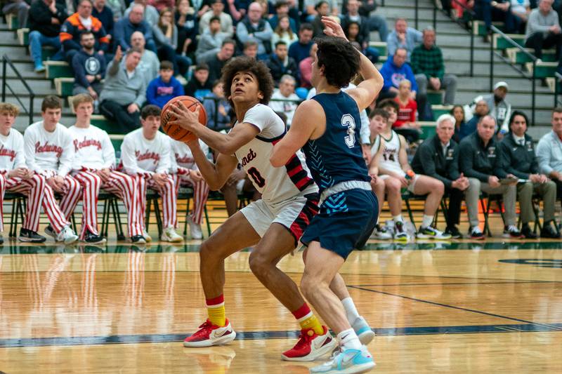 Benet’s Brayden Fagbemi (0) plays the ball in the post against Lake Park's Adrian Notardonato (3) during a Bartlett 4A Sectional semifinal boys basketball game at Bartlett High School on Tuesday, Feb 28, 2023.