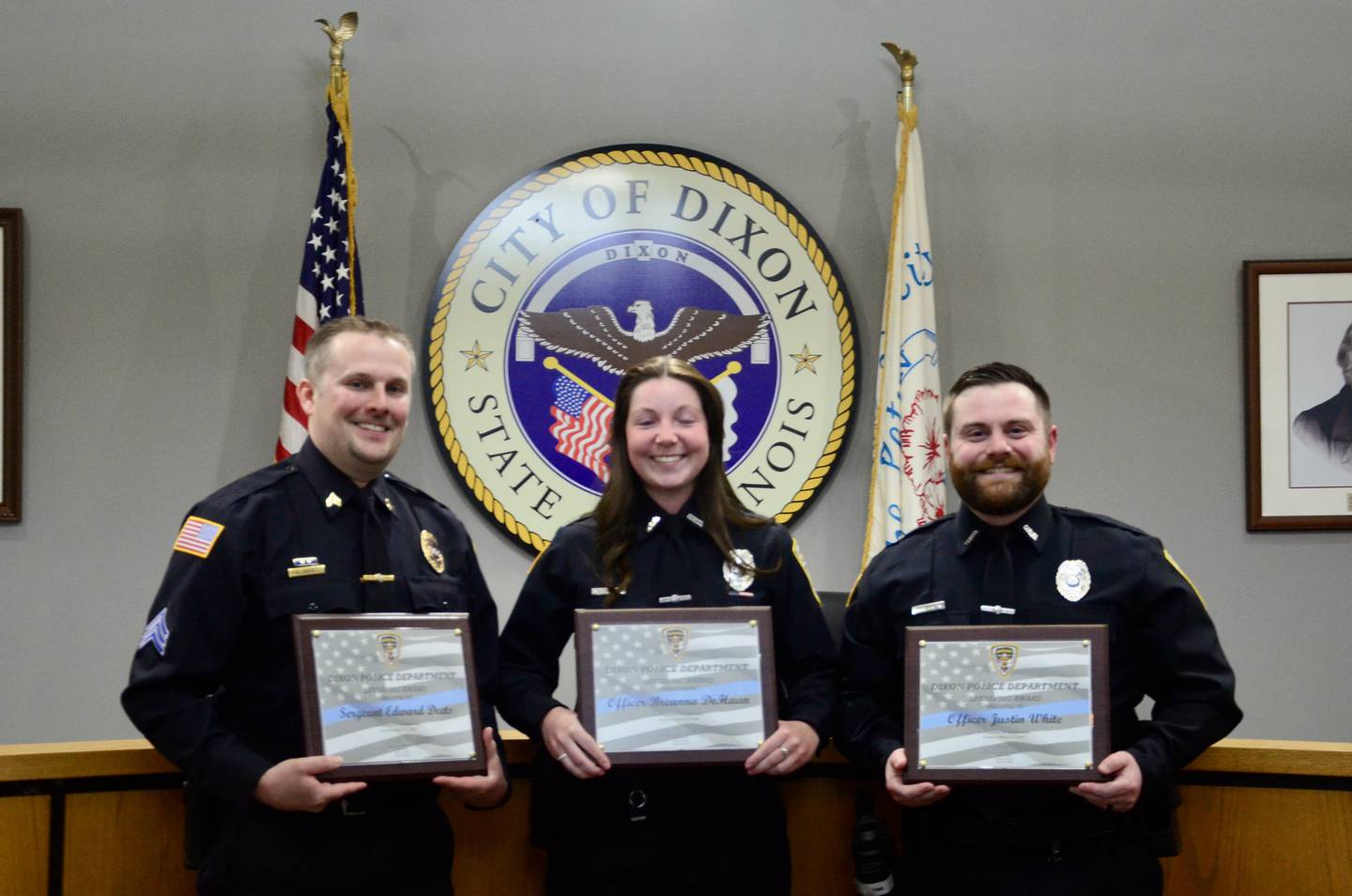 Dixon Police Sergeant Ed Deets, Officer Breanna DeHaan and Officer Justin White (left to right) smile after accepting their life saving awards at the city council meeting, Monday, April 20, 2026.