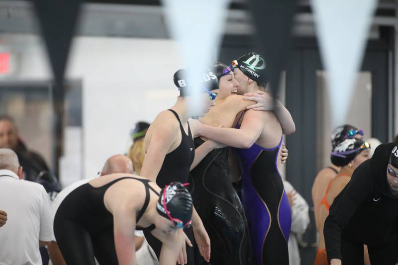 York swimmers celebrate following the 200-yard medley relay consolation heat during the IHSA Girls State Championships on Saturday, Nov. 16, 2024 at FMC Natatorium in Westmont.