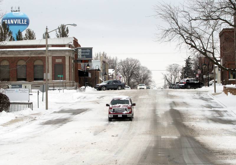 A pickup truck drives downtown snow covered McCoy Street in Granville on Thursday, Feb. 3, 2022.