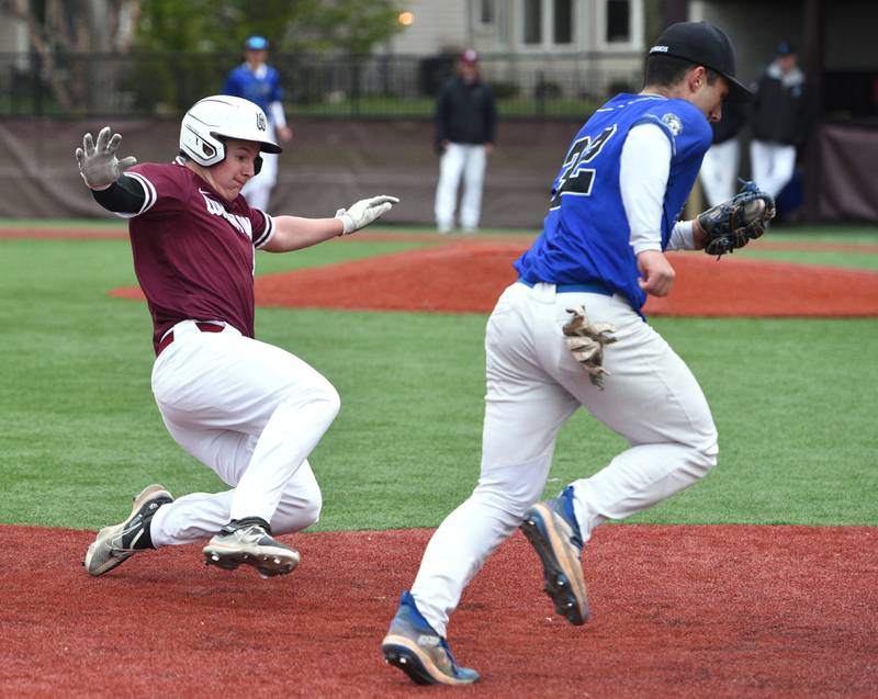 Wheaton Academy's Will Clegg, left, starts his slide into third base but St. Francis' Rocco Tenuta steps on the bag to get the out during Tuesday’s baseball game in West Chicago.