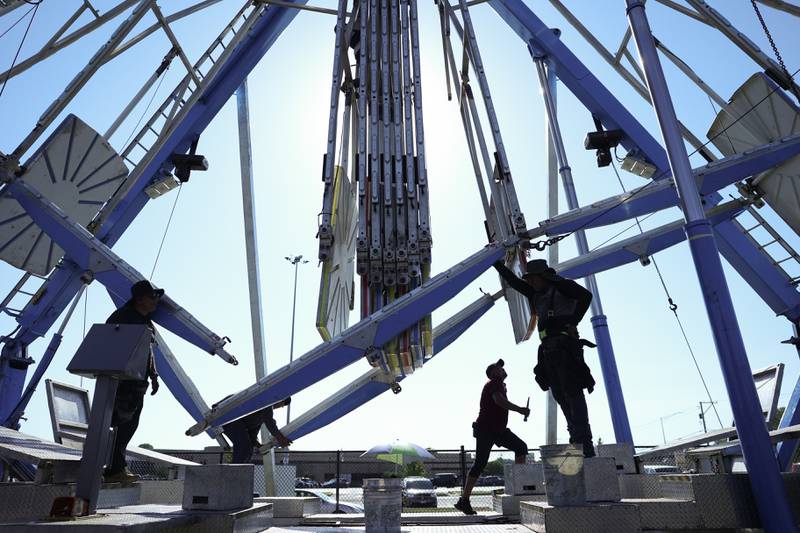 Workers set up the Ferris wheel Tuesday inside Joliet Memorial Stadium for the Taste of Joliet set for June 24th through the 26th. Tuesday, June 21, 2022 in Joliet.