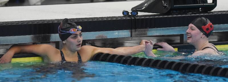Hinsdale Central’s Burlingtyn Bokos, left, shakes hands with event winner Jenna Kerr of Barrington at the conclusion of the 500-yard freestyle during the IHSA girls state swimming finals at FMC Natatorium in Westmont on Saturday, Nov. 12, 2022.