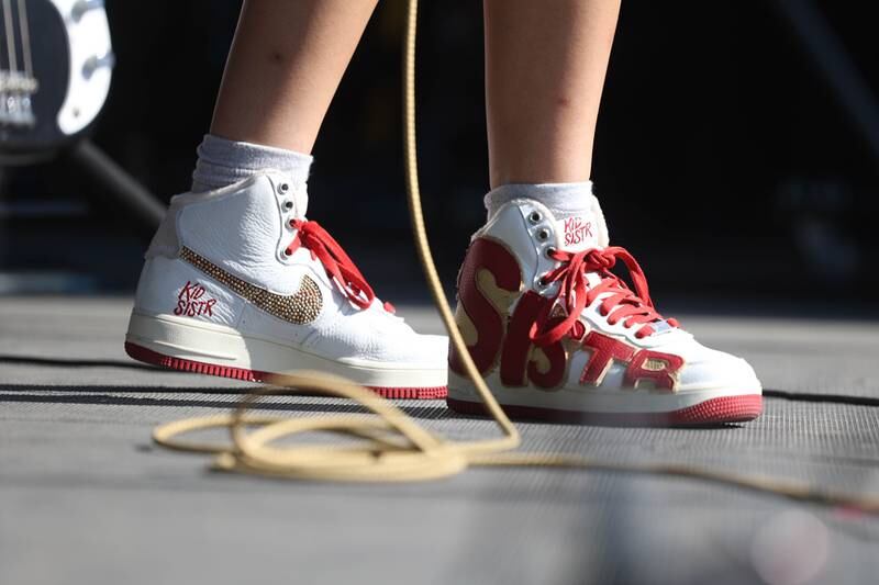 Kid Sister bassist Sara Keden wears custom Nikes during their performance on the Rebel stage on day three of Riot Fest. Saturday, Sept. 18, 2022, in Chicago.