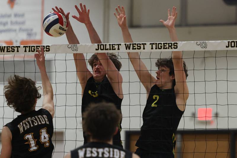 Providence’s Kaden Kaczmarek (right) provides a wall as Sean Kane gets the block against Joliet West on Thursday, March 23, 2023 in Joliet.