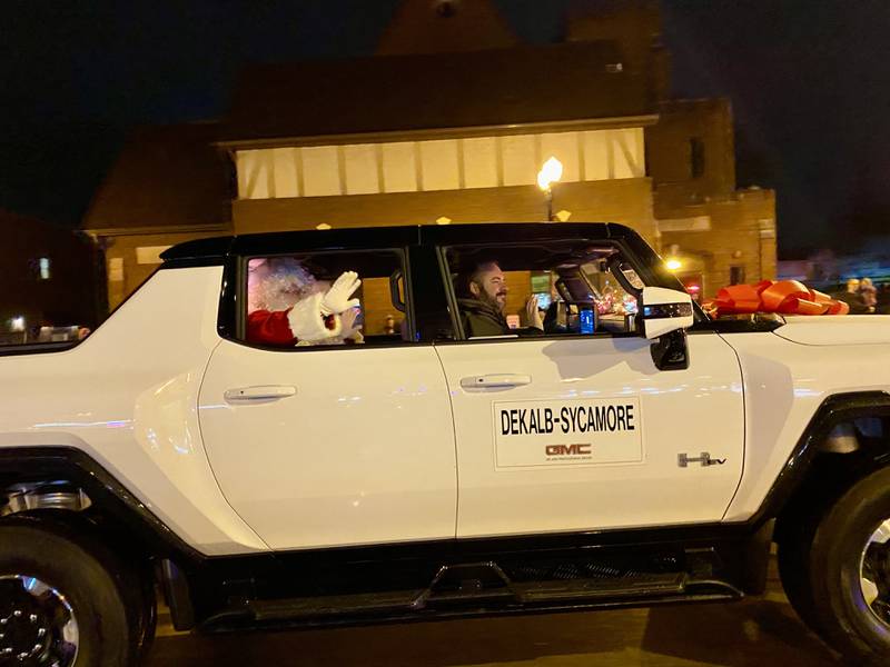 Santa Claus and Mrs. Claus wave to the crowd as they arrive to greet excited children and families in downtown Sycamore for Discover Sycamore's annual Walk with Santa on Friday, Dec. 1, 2023.