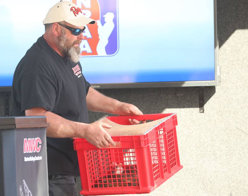 Dave Gossar of Serena, carries his basket of fish off of the stage during the annual Masters Walleye Circuit tournament on Friday, March 20, 2026 at the Spring Valley Boat Club.