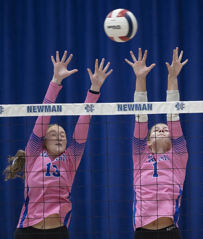 Newman’s Kennedi Shippert (left) and Lauren McClain go for the block against Erie-Prophetstown Tuesday, Oct. 14, 2025.
