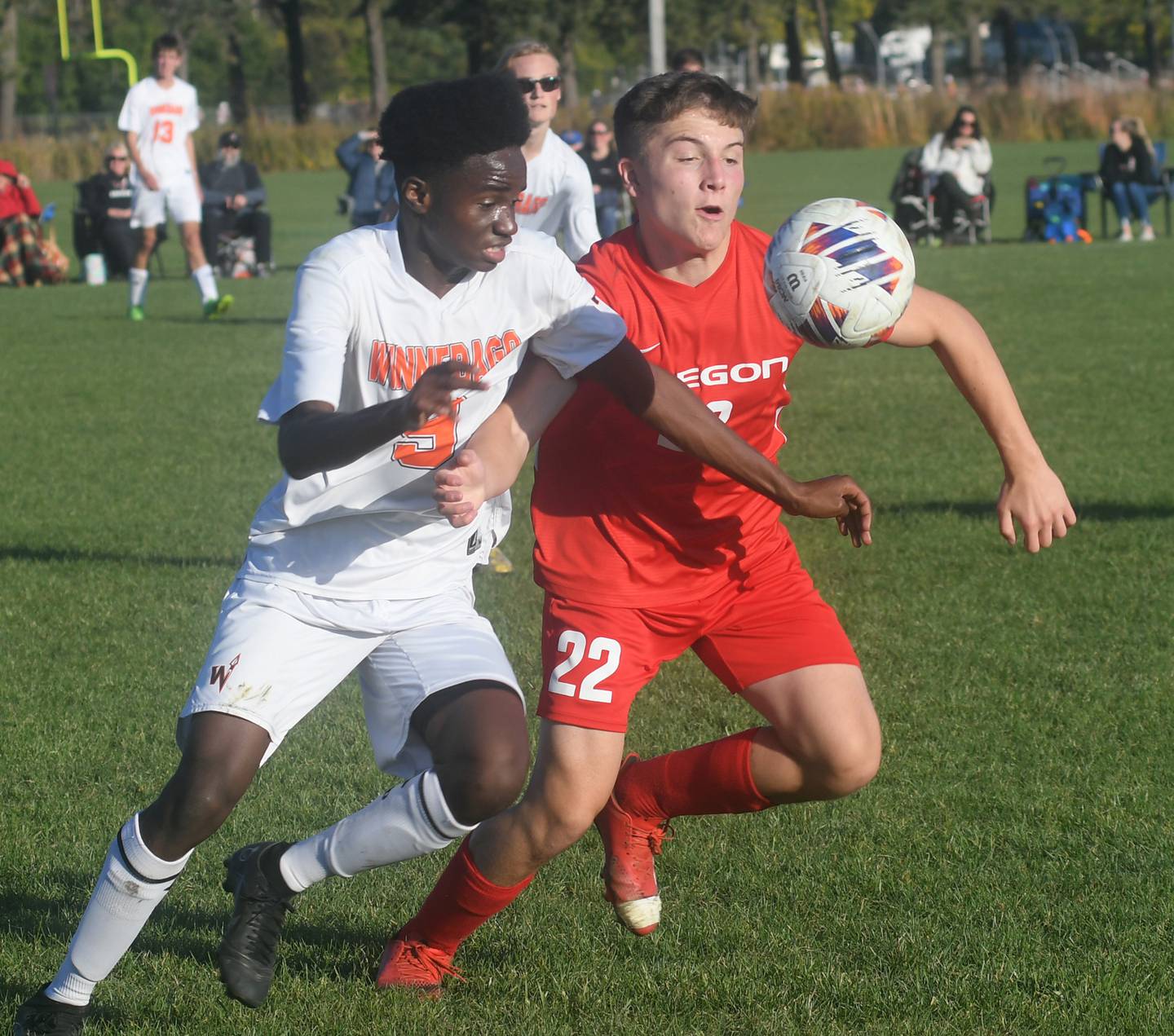 Oregon's Grant Stender (22) and Winnebago's Henry Snyder fight for a ball during Class 1A regional action in Oregon on Wednesday. The Hawks won the game on penalty kicks after two overtime periods.