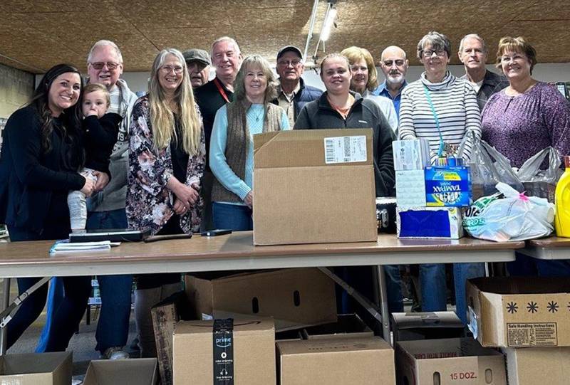 Morrison Food Pantry volunteers and those who donated are (from left) Homestead Executive Director Shelby Engaldo with son Enzo; Rick Barr; Resthave Activity Director Dawn Stuart; Richard Swanson; Morrison Hospital Marketing Director Mick Welding; Deb Wikoff; Randy Kuehl; Amanda McNamara; Carole Patton; Len Ashlin; Leveda Ashlin; Rick Smith; and Resthave Marketing Director Karla Burn.
