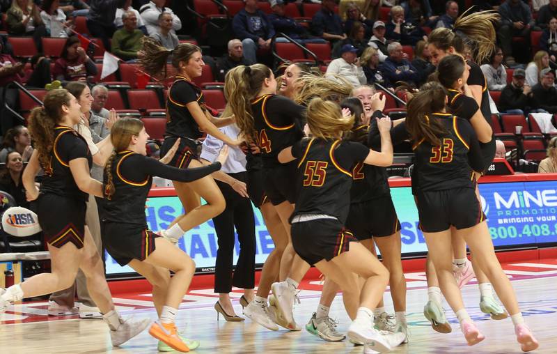 Members of the Montini girls basketball team react after defeating Quincy Notre Dame during the Class 3A State semifinal game on Thursday, March 6, 2025 at CEFCU Arena in Normal.