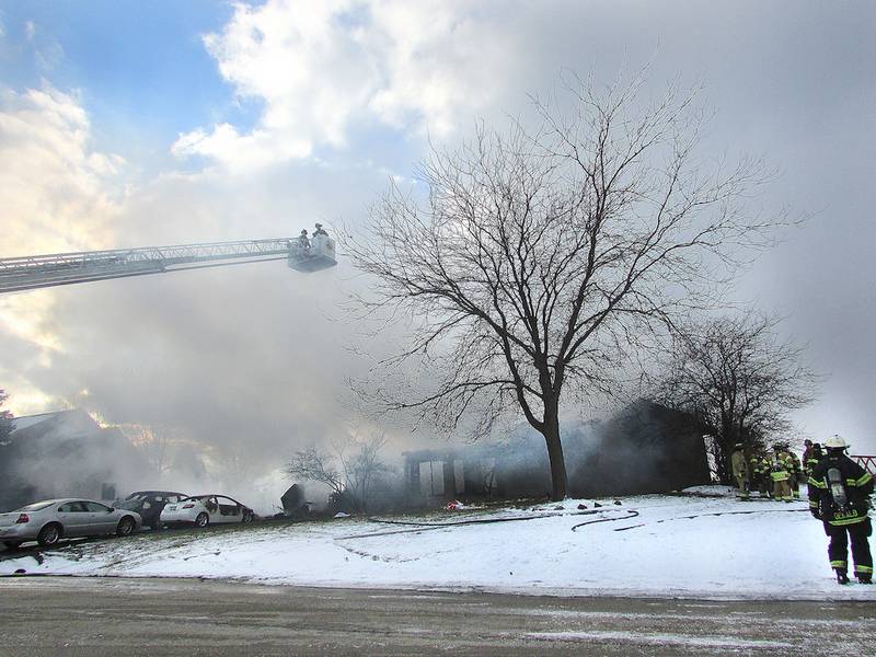 Firefighters from Genoa-Kingston, Hampshire, Sycamore, Kirkland and DeKalb fight the fire that consumed most of this Genoa home on Thanksgiving in 2014.  The family said the fire started in the garage while they were preparing Thanksgiving dinner.