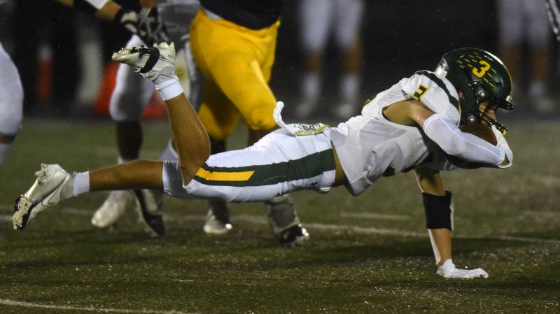 Glenbrook North's Reese Marquez dives forward for extra yards during Friday’s game against Glenbrook South.