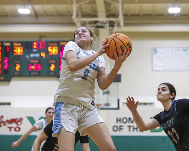 Downers Grove South's Abby Gray (1) grabs a rebound before going back up to score during their York Thanksgiving Tournament matchup between Oswego East at Downers Grove South Friday, Nov 20, 2025 in Elmhurst.