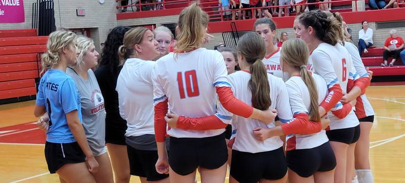 Ottawa coach Jenn Crum (third from left) gives her Pirates instruction between games of Thursday's match against Streator in Kingman Gym.