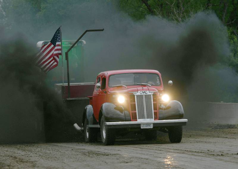 Todd Hollis creates a huge plume of black smoke with his 1938 GMC truck as he pulls the sled at the Forreston FFA Alumni Tractor and Truck Pull during Leaf River Summer Daze on June 4. THe truck, powered by a 2007 GMC Duramax diesel, came from South Dakota. Hollis, of German Valley, added two cabs and leather seats while creating the specialty truck in 5-6 years.